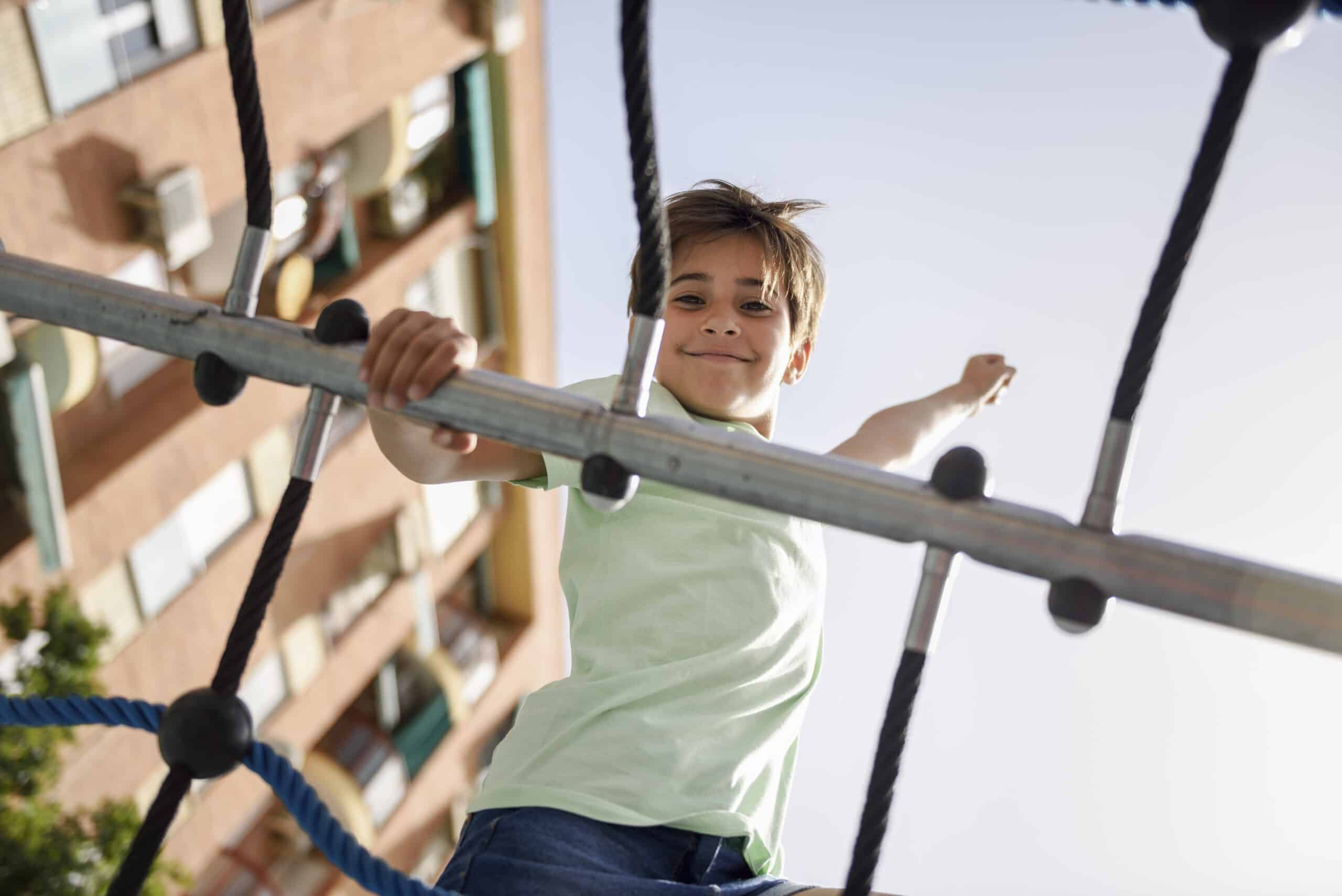 Portrait of little girl on climbing frame